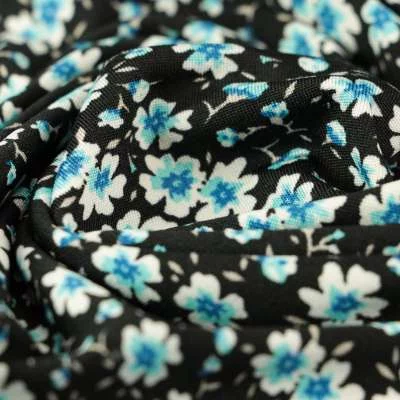 Tissu venezia motifs fleuri bleu sur fond noir Vendu Au Coupon