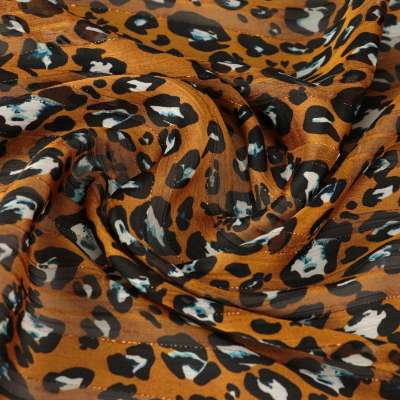 Tissu mousseline Oslo a motif léopard sur fond moutarde  vendu au coupons