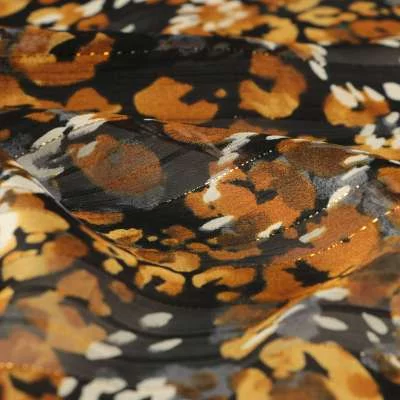 Tissu mousseline lurex Oslo motif léopard sur fond noir vendu au coupons