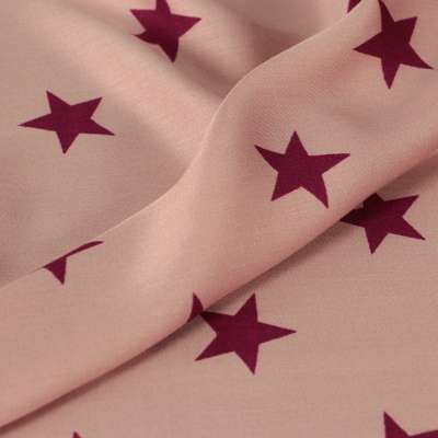 Fibranne viscose motif étoiles sur fond rose vendu au coupon