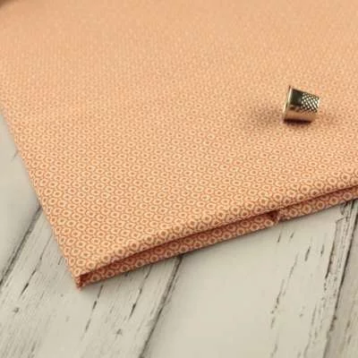 Tissu popeline coton orange motifs graphique vendu au coupon