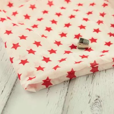 Tissu voile de coton blanc Imprimé étoile rouge vendu au coupon