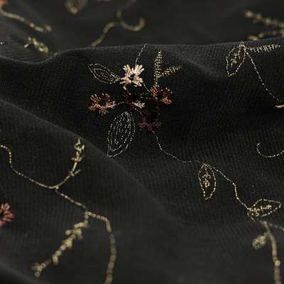 Tissus Resille brodée motif fleuris sur fond noir vendu au coupon