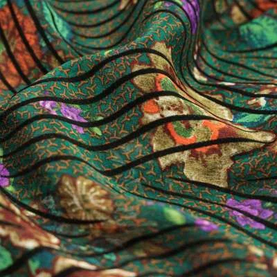 Mousseline imprimé floqué motif fleurs sur fond vert