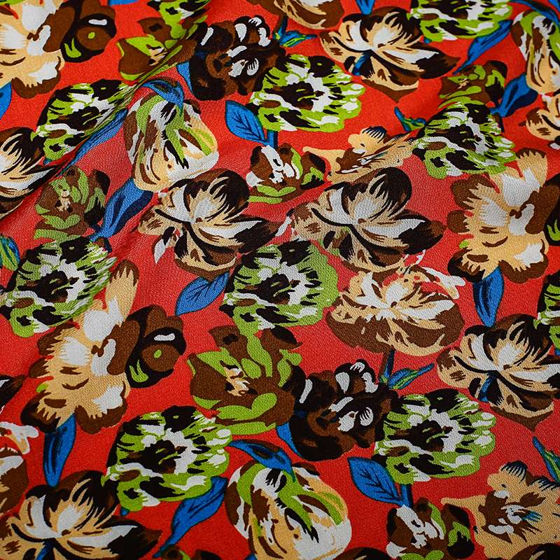 Tissu viscose de haute qualité fond orange motif floral vendu au coupon