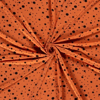 Tissu jersey de viscose pois noir sur fond orange