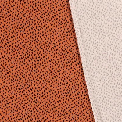 Tissu jersey de viscose imprimé taches noir fond orange pour couture