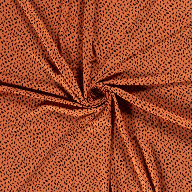 Tissu jersey de viscose imprimé taches noir fond orange