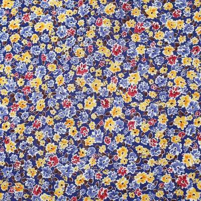 Popeline de Coton motif champs de fleurs sur fond marine
