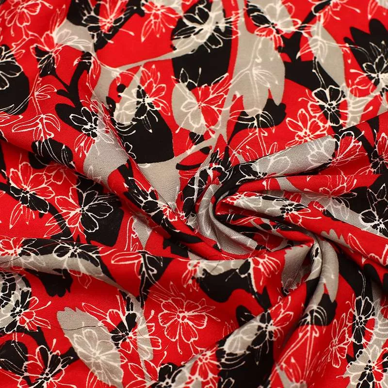 Tissu Crêpe Polyester imprimé fleurs sur fond corail