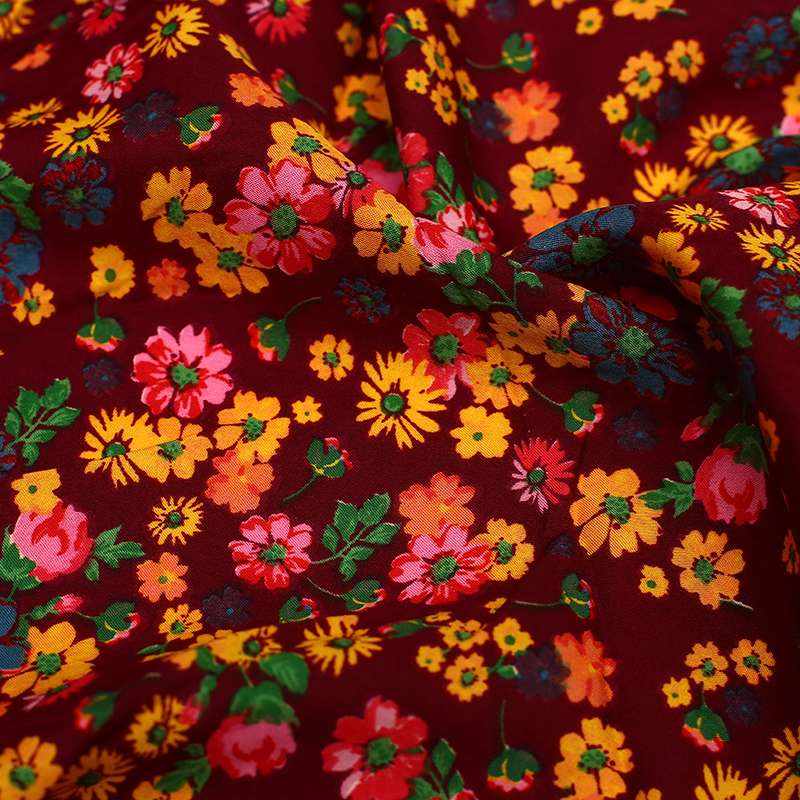 Tissu crêpe polyester imprimé fleurs sauvages fond bordeaux Commandez dès maintenant pour une livraison rapide !