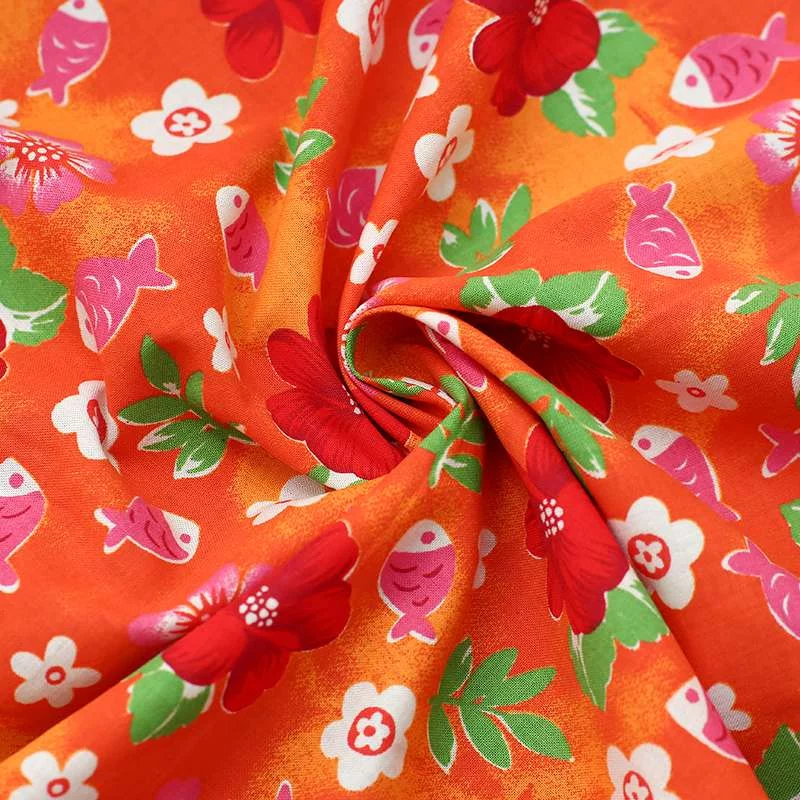 Tissu popeline de coton fond orange avec motif : Fleurs et poisson