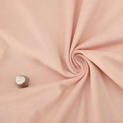 "Tissu Jersey en Coton Saumon : Idéal pour Vos Projets de Couture"