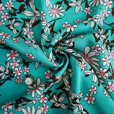 Tissu fibranne de viscose turquoise avec fleurs printanières