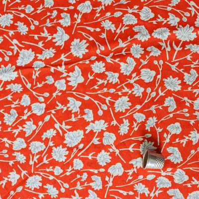 Tissu microfibre orange imprimé floral blanc pour jupes et robes