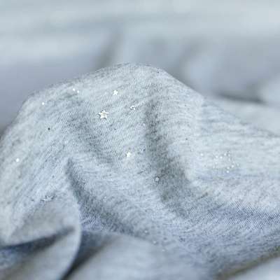 Tissu jersey à petites étoiles argentées pour vêtements chics