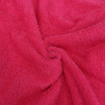 Tissu éponge uni fuchsia, pour des créations de bain chics et joyeuses.