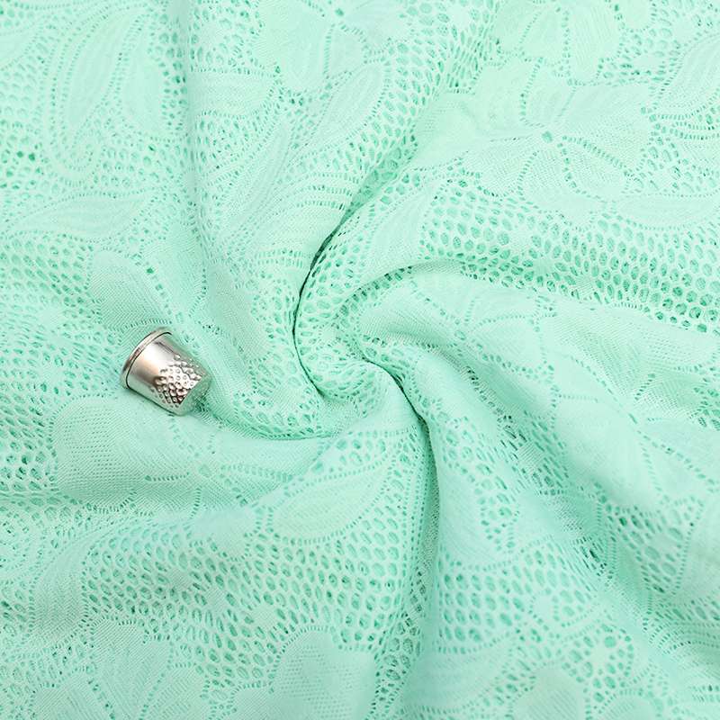 Tissu dentelle menthe à motif floral, idéal pour des robes élégantes